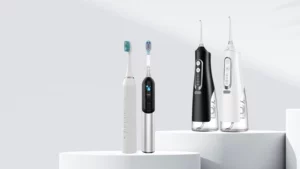 Oral care product line with two electric toothbrushes and two cordless water flossers on white studio pedestals