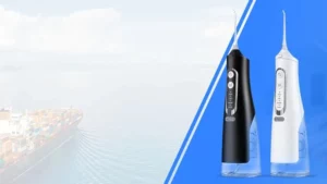 Two cordless water flossers on a blue panel beside a container ship at sea